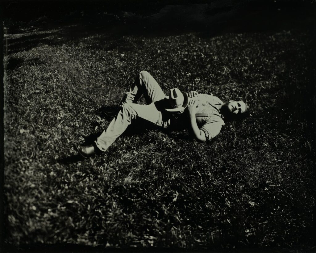 Folk Singer Willi Carlisle floating in a field of fescue at tintype studio Arkansas Momentos in downtown Rogers AR. October 2021